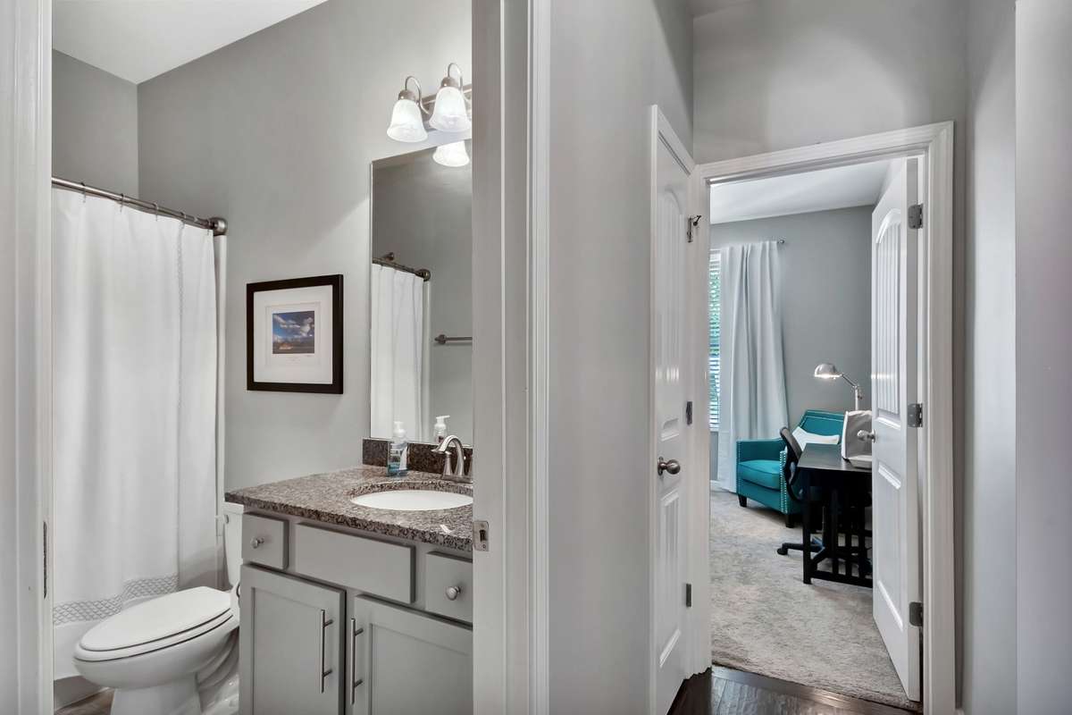The bathroom is located between the second and third bedrooms.