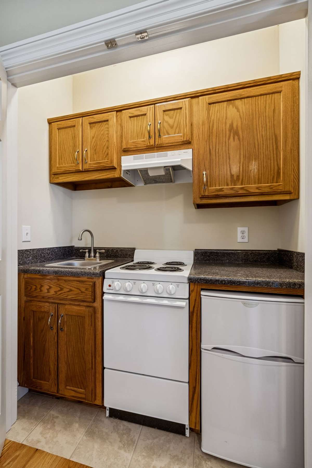 Kitchenette hidden behind closet doors in one the secondary bedrooms offers a unique opportunity for a separate living space for visitors, or ???