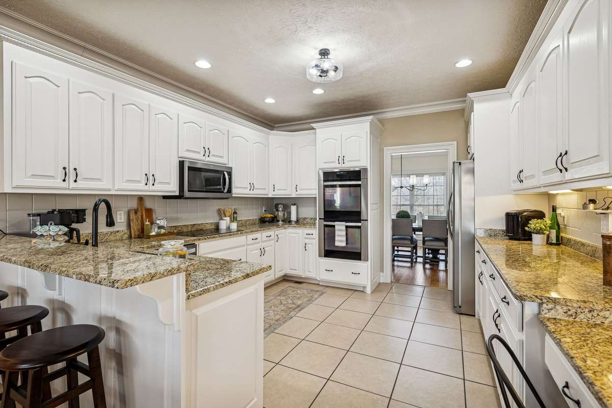 Painted White Cabinets, New Lighting, Granite Countertops, Double Ovens both are convection, Separate Microwave