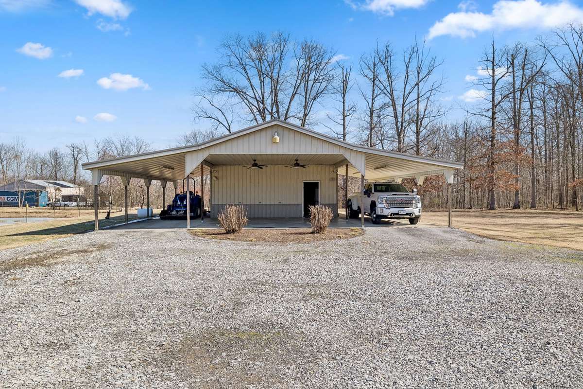 48 x 48 Metal Barn with dual side carports and front covered awning