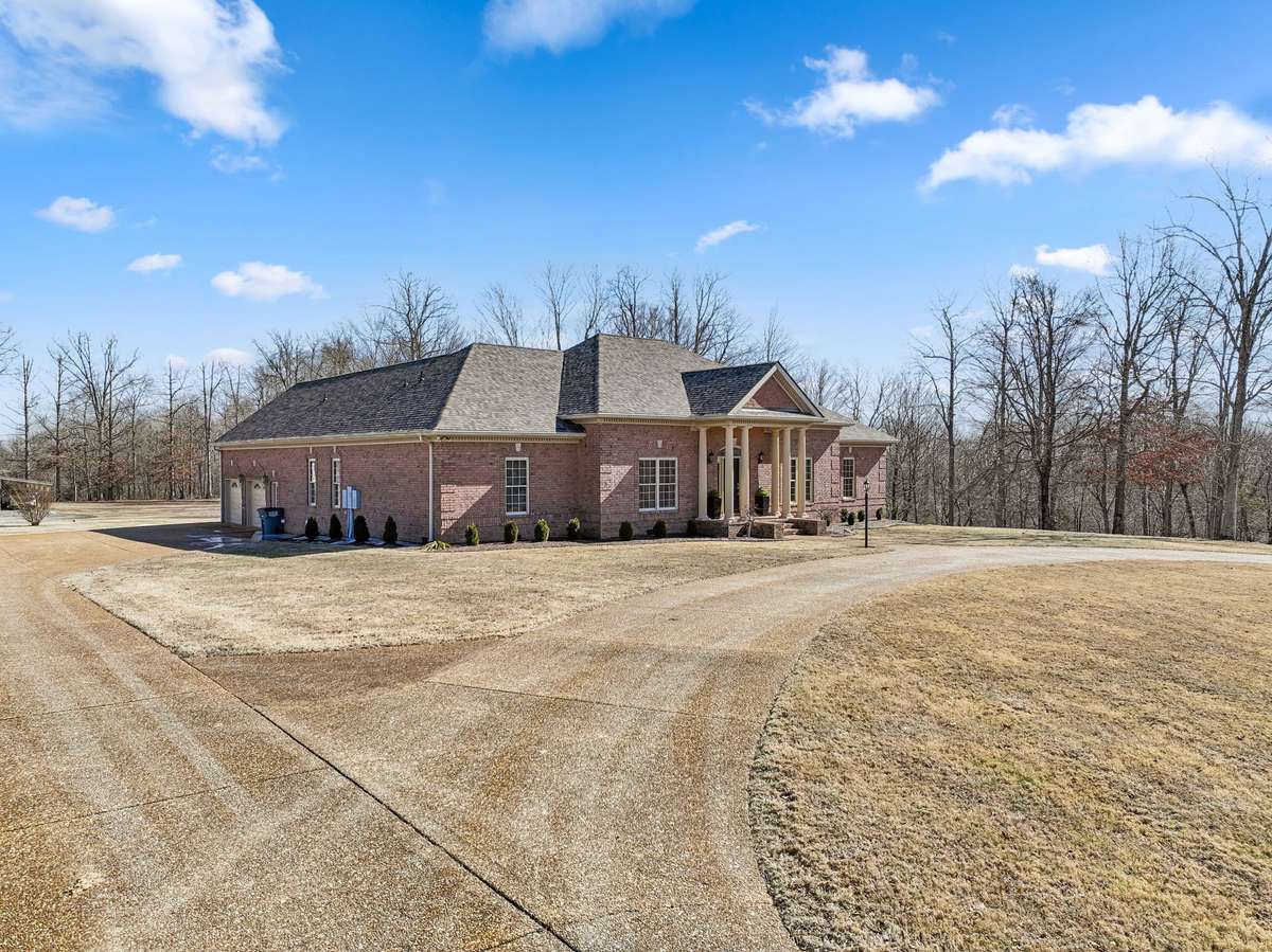 Circular Driveway to front door and then driveway leads to side entrance garage