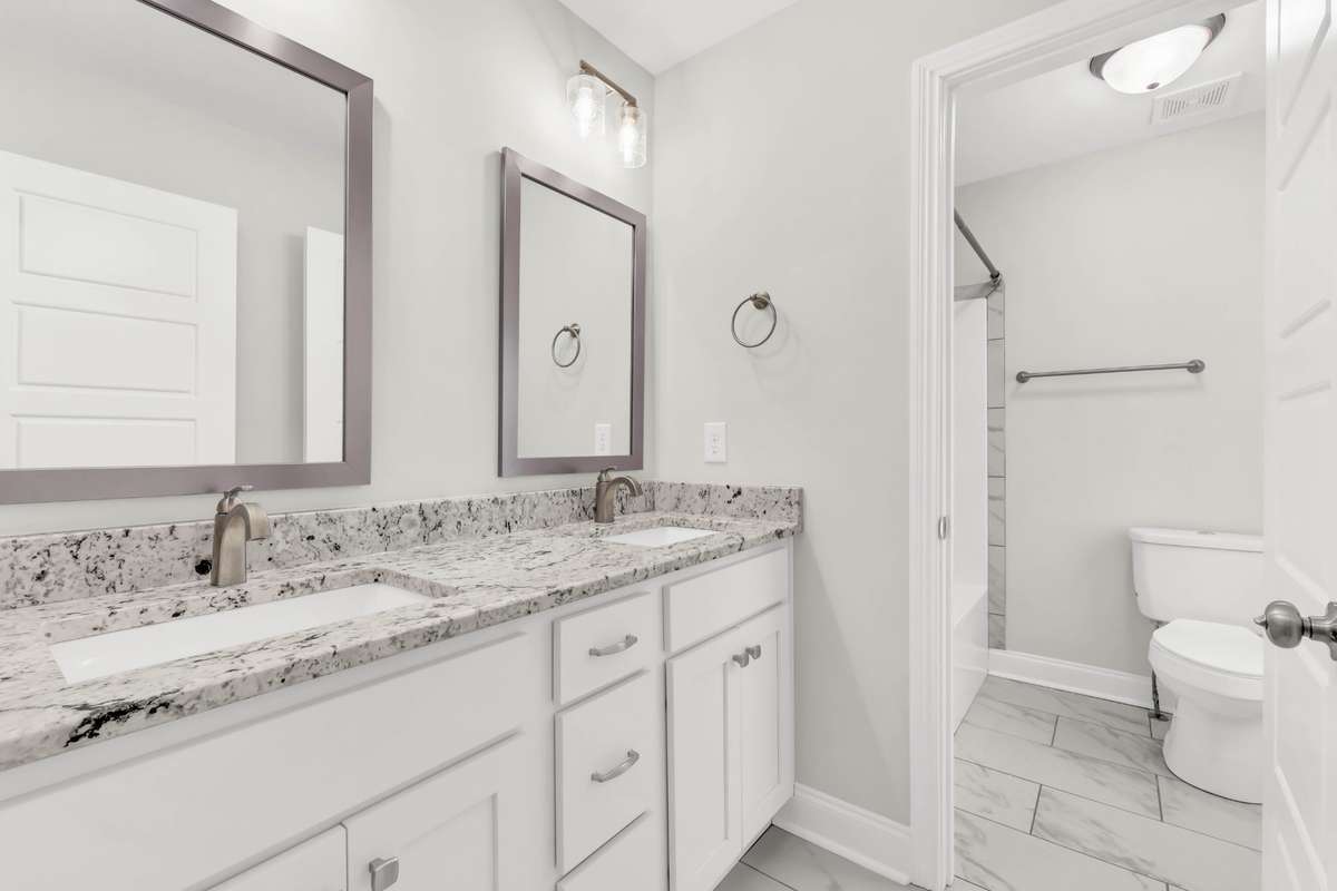 The bathroom upstairs is very well laid out with double vanities and granite countertops.