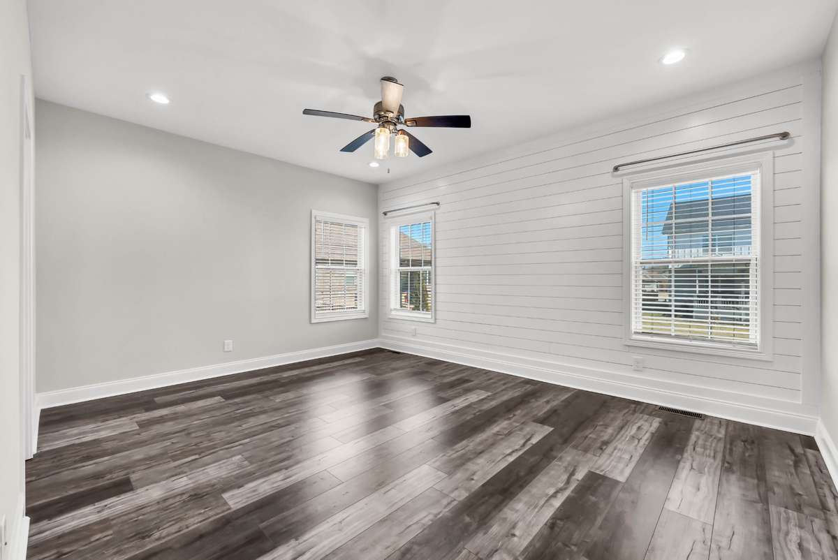 The primary suite is a dream with it's shiplap trim and lots of windows!