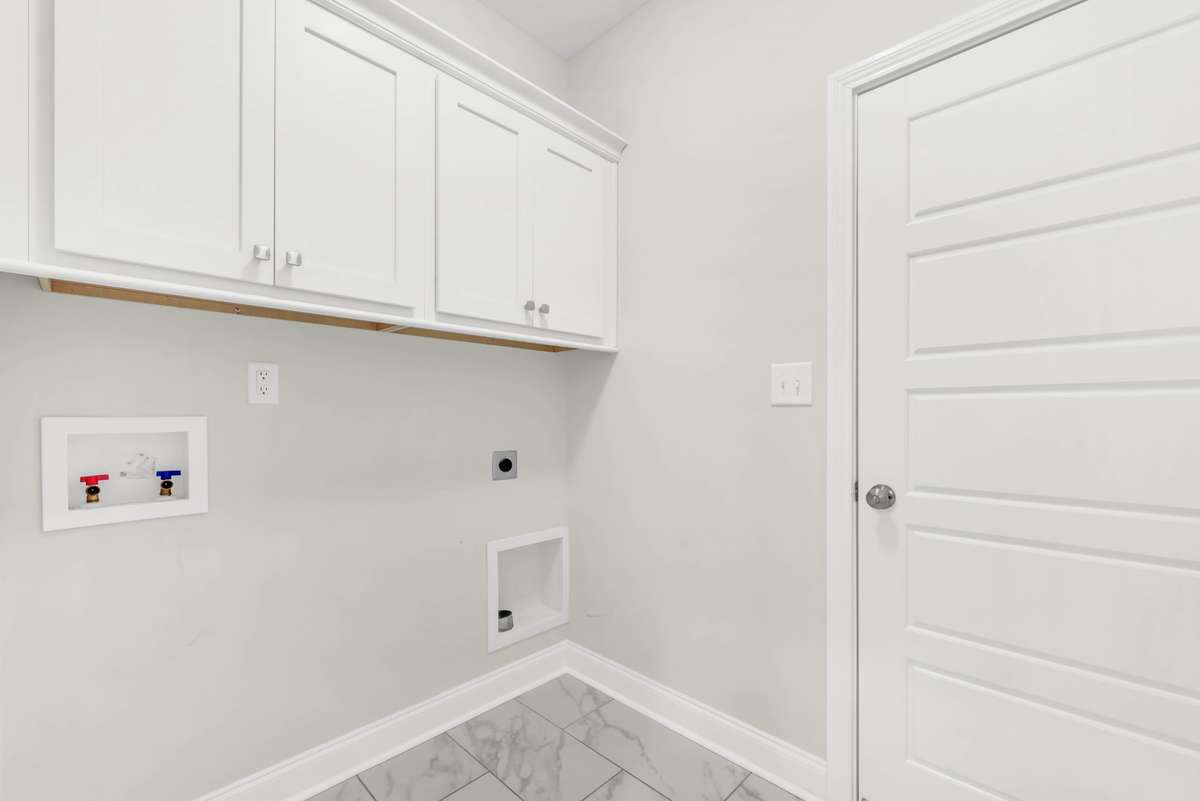 The laundry room is off the garage area and has lots of space and cabinets.