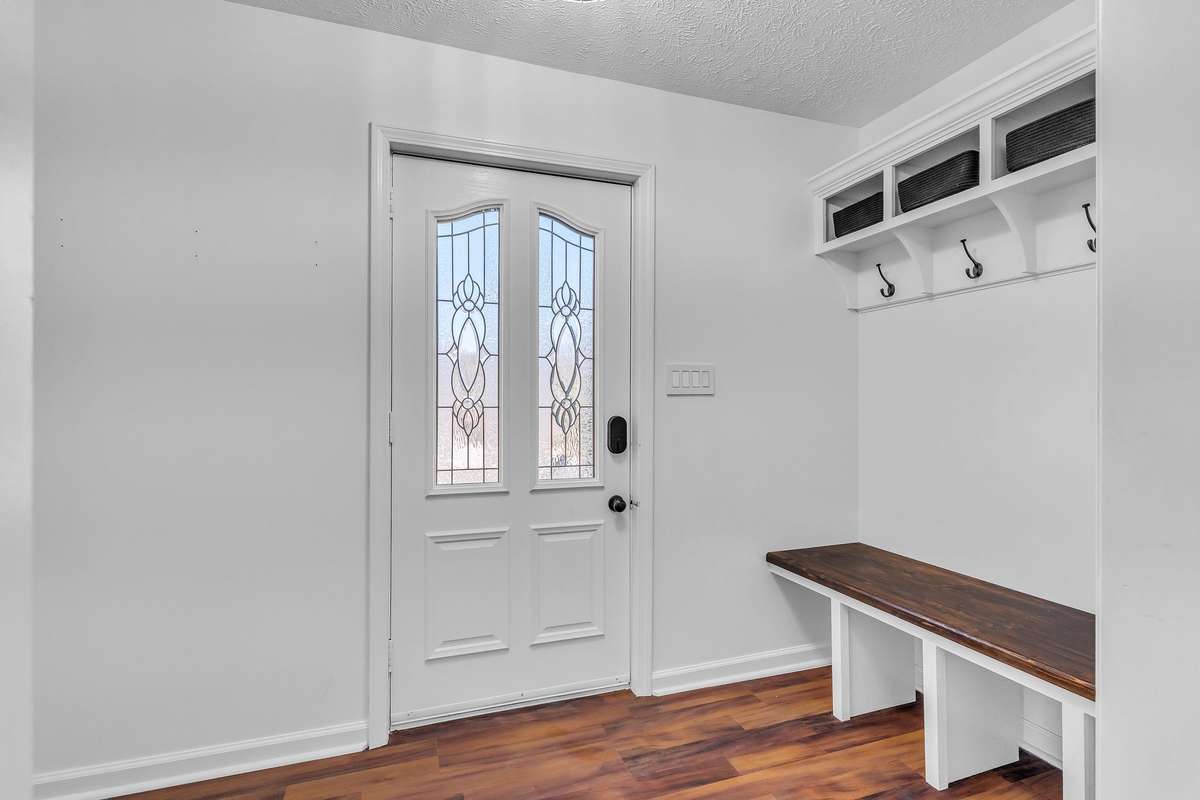 Entry foyer is equipped with custom built-ins creating a perfect drop zone for functionality and organization.