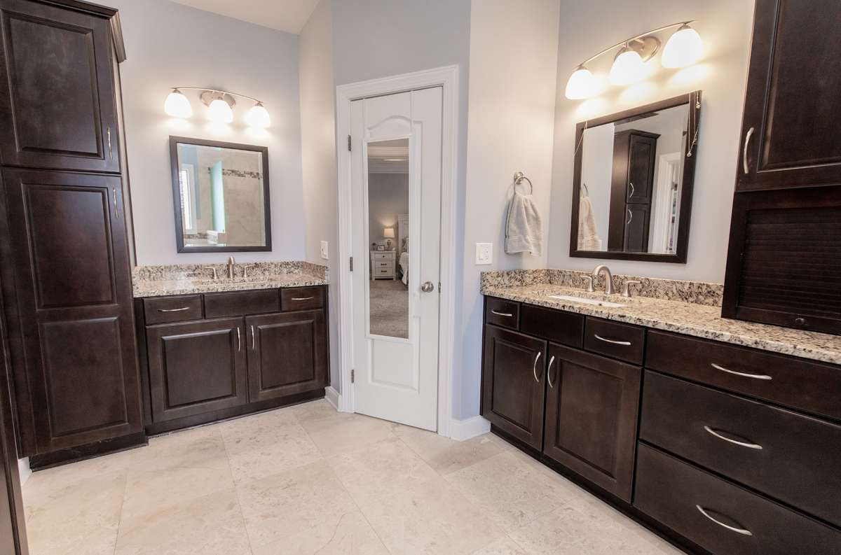 Two vanities, LOADS of cabinet storage, private water closet, and separate shower and tub