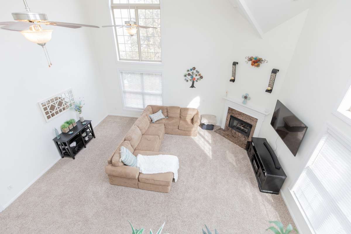 This family room is a show stopper! Right off other side of kitchen- making it perfect for family play time or entertaining. Floor to ceiling windows create such a bright space. Perfect for sunny warm days, or cozy up by the fire in the winter.