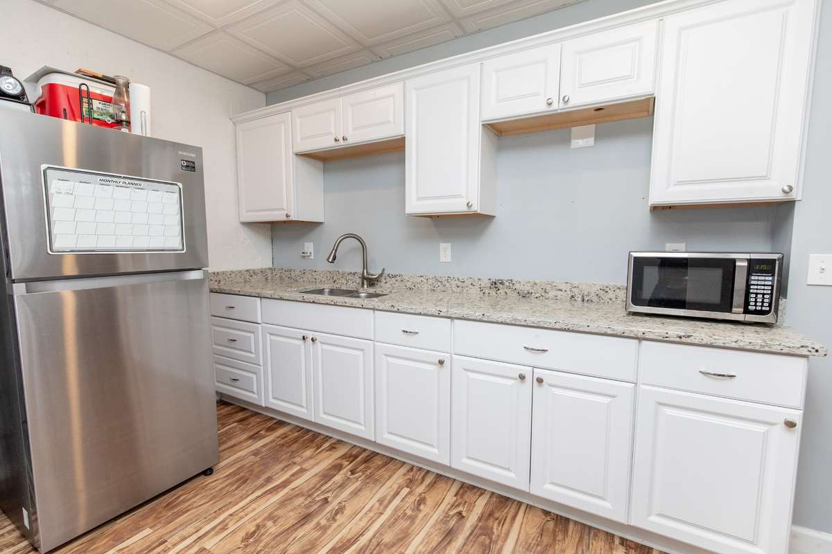 Kitchenette makes this area perfect for parents, relatives or older teens. Or keep as a fun rec room / out of town company area.