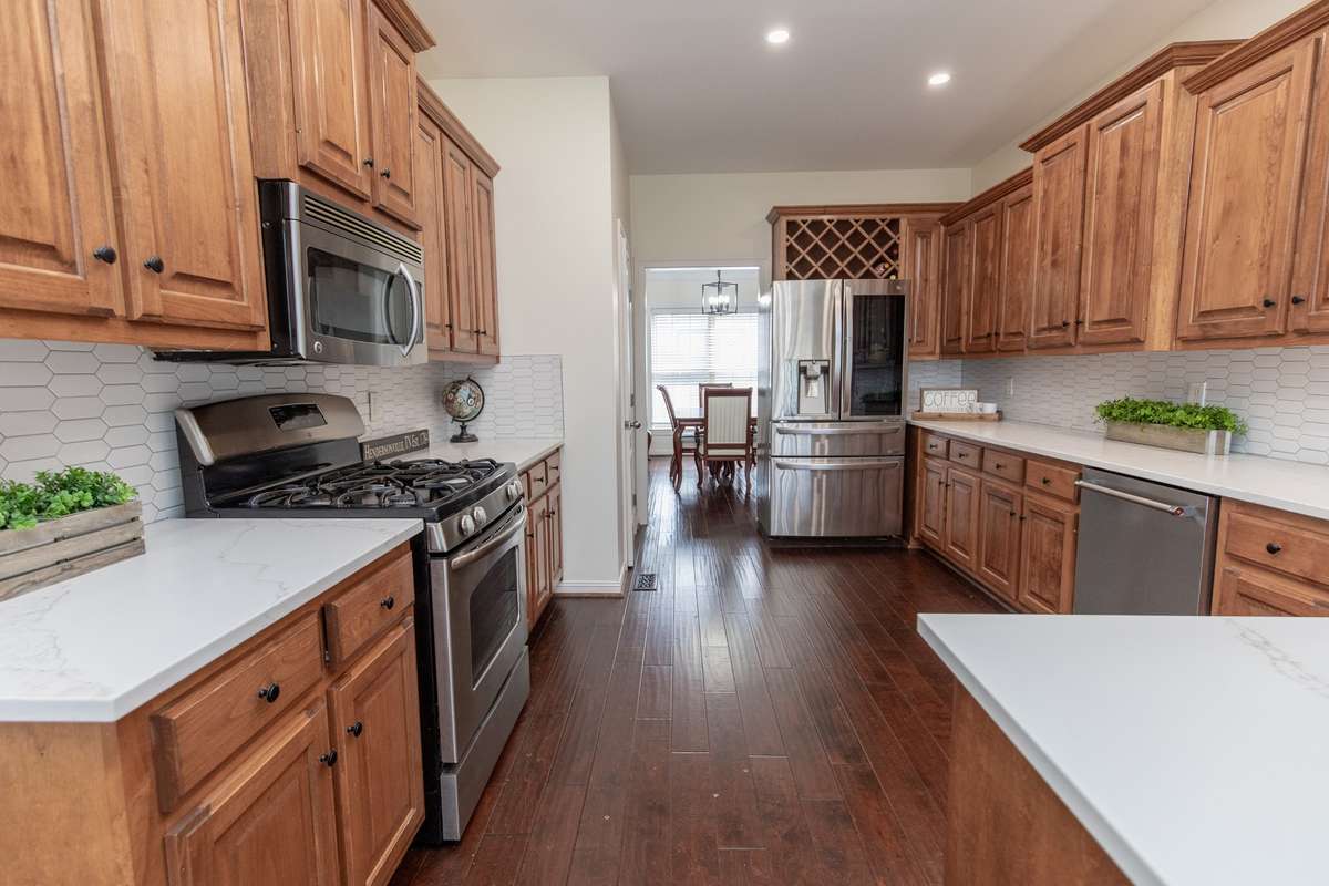 Kitchen leads to dining room on one side and breakfast nook on other. Plenty of room for family gatherings or hosting holidays and parties