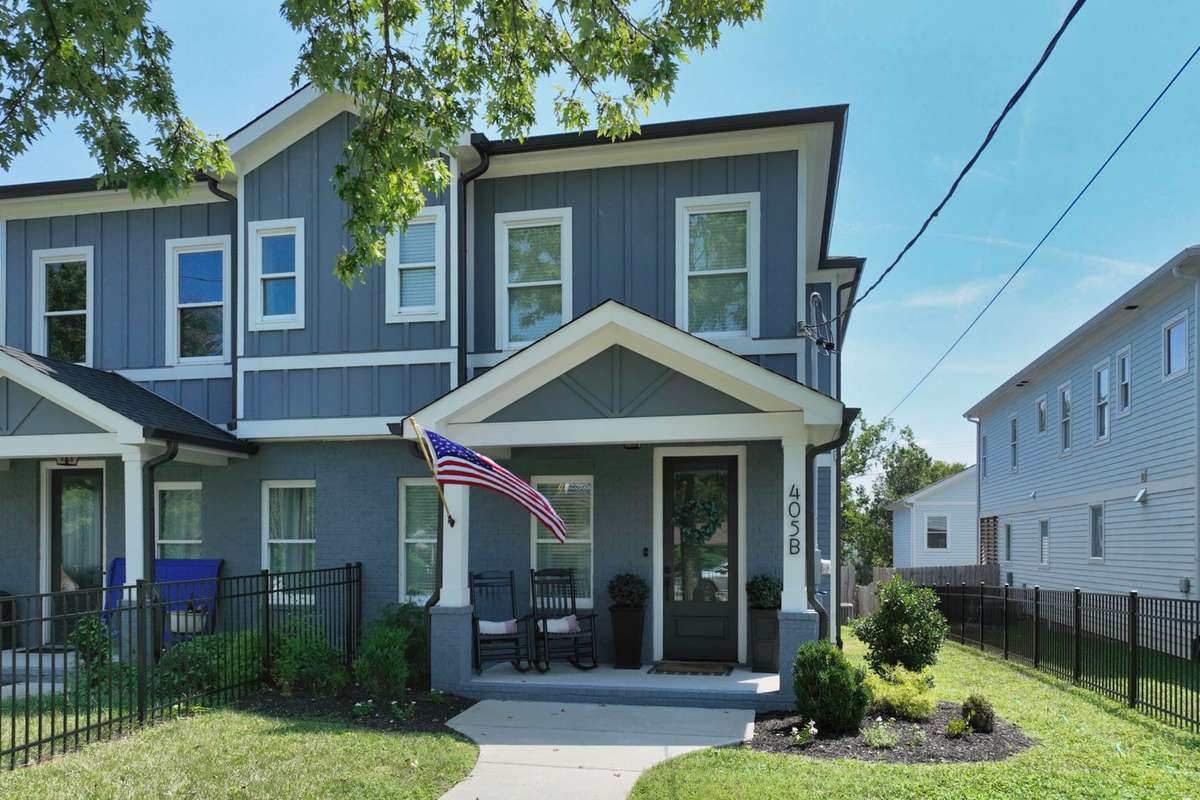 Gorgeous front of home with front yard and back yard fence.