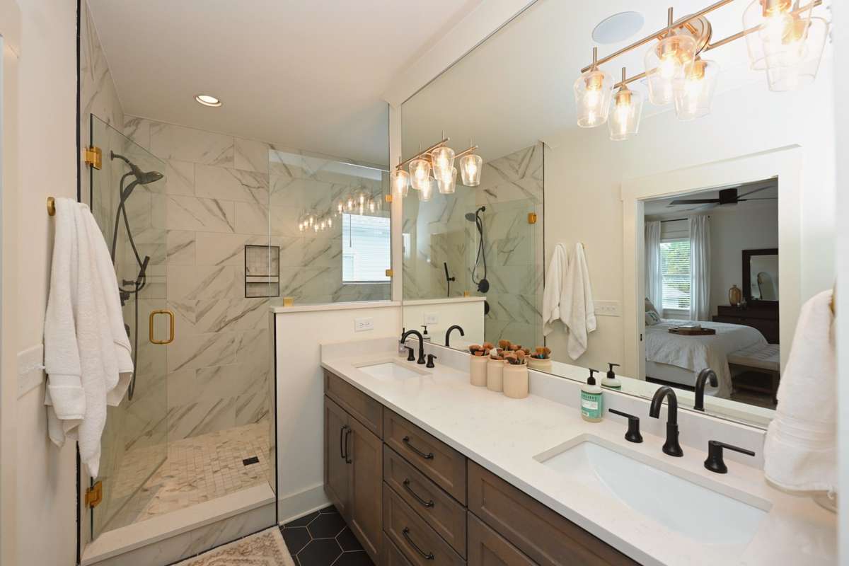 Primary bath has double sinks, large shower and tub