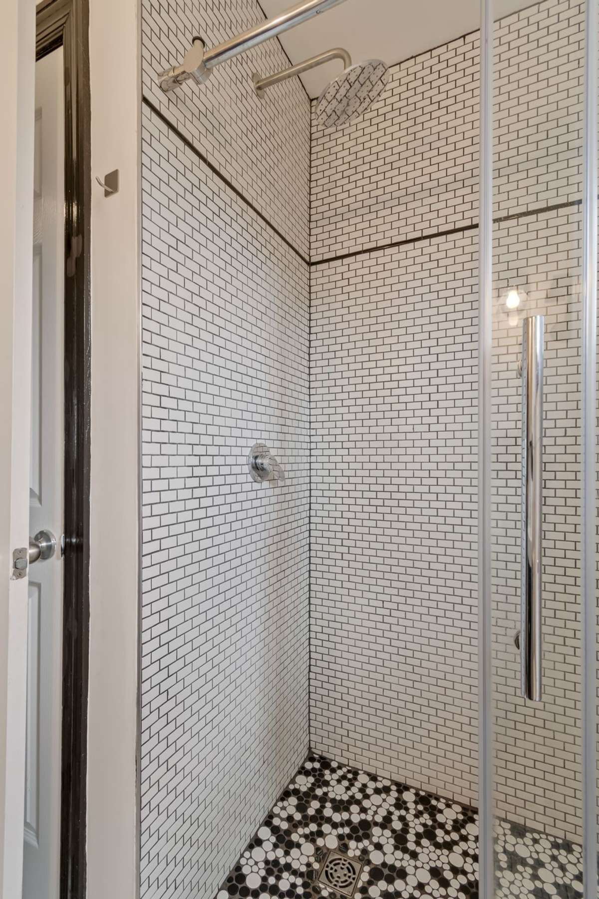 The bathroom also has another linen closet beside the shower.