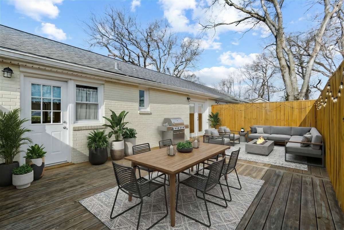 Digitally staged huge back deck with access to the kitchen and bedroom.