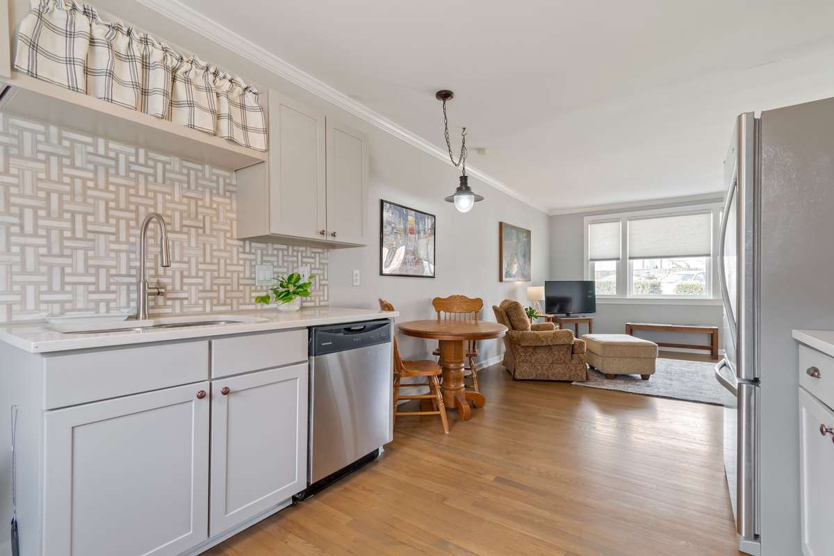 Fresh tiled walls and newer countertops are white and bright.