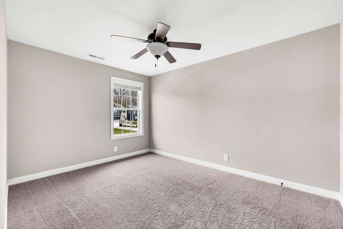 Bedroom three with ceiling fan. Buyer to select flooring for all carpeted areas, which is on-site.