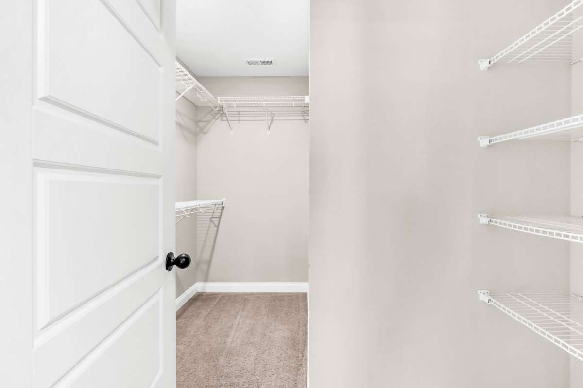 Walk-in closet with shelving in primary suite