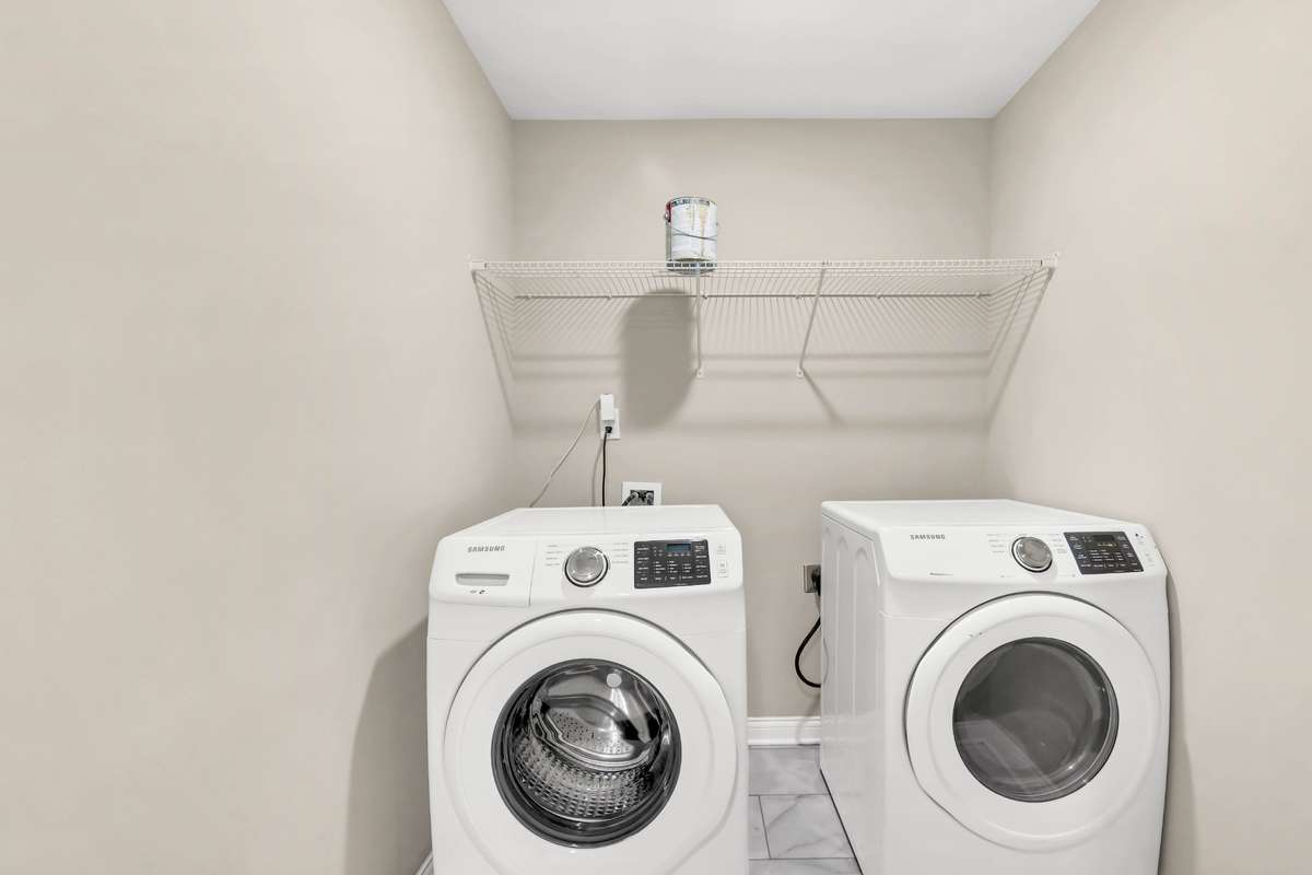 Big utility room with tile flooring. Washer and dryer remain!