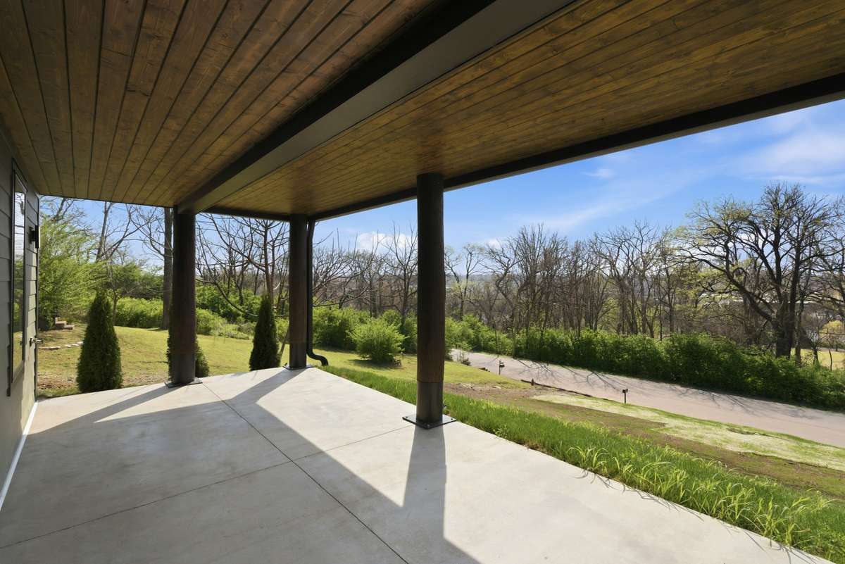 Lower Level: Stunning covered concrete patio looking out over the uninterrupted and protected views of the golf course and Shelby Park.