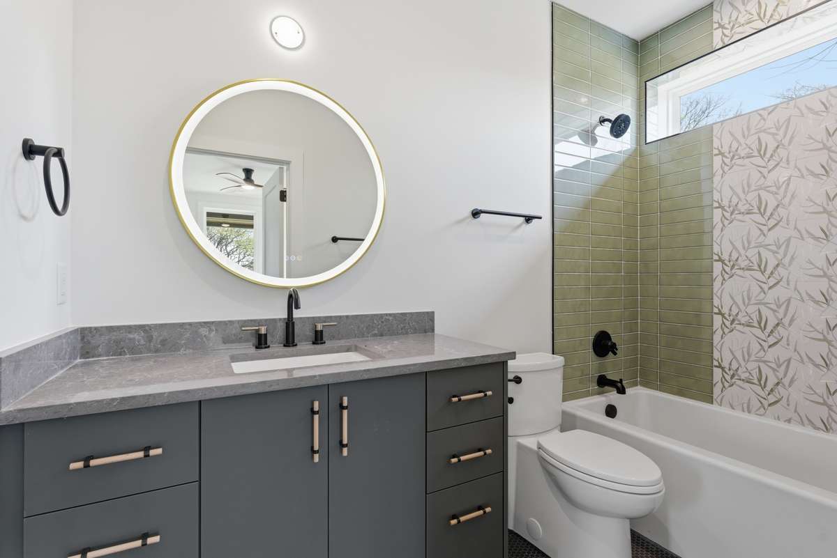 Lower Level - Bathroom 4: Designer guest bath with custom tile, modern vanity, front-light mirror and curated finishes, offering a spa-like experience for guests and everyday living.