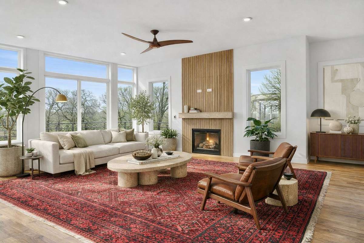 Natural light pours through oversized windows, framing park views and creating a calm, elevated living space centered around a modern fireplace.