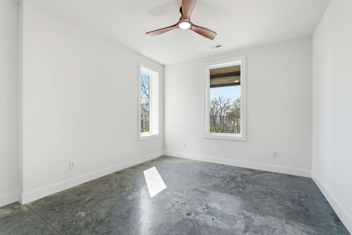 Bedroom 4: Lower-level apartment with polished concrete floor.