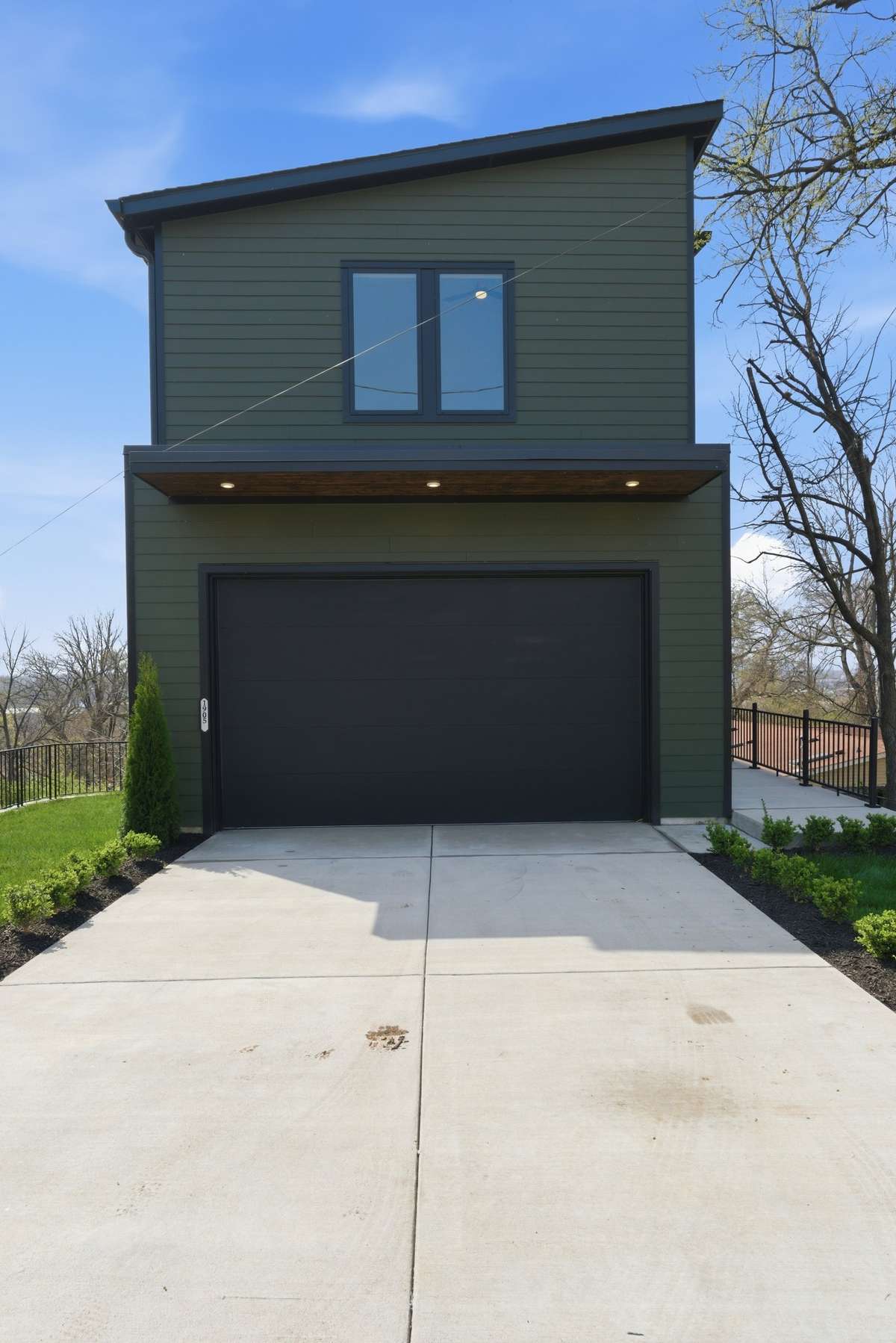 Clean modern architecture w/premium siding, custom soffit lighting & a sleek oversized garage, designed w/durability, simplicity, and curb appeal in mind. Alley access for garage. Additional parking spaces are available at the top or bottom property.