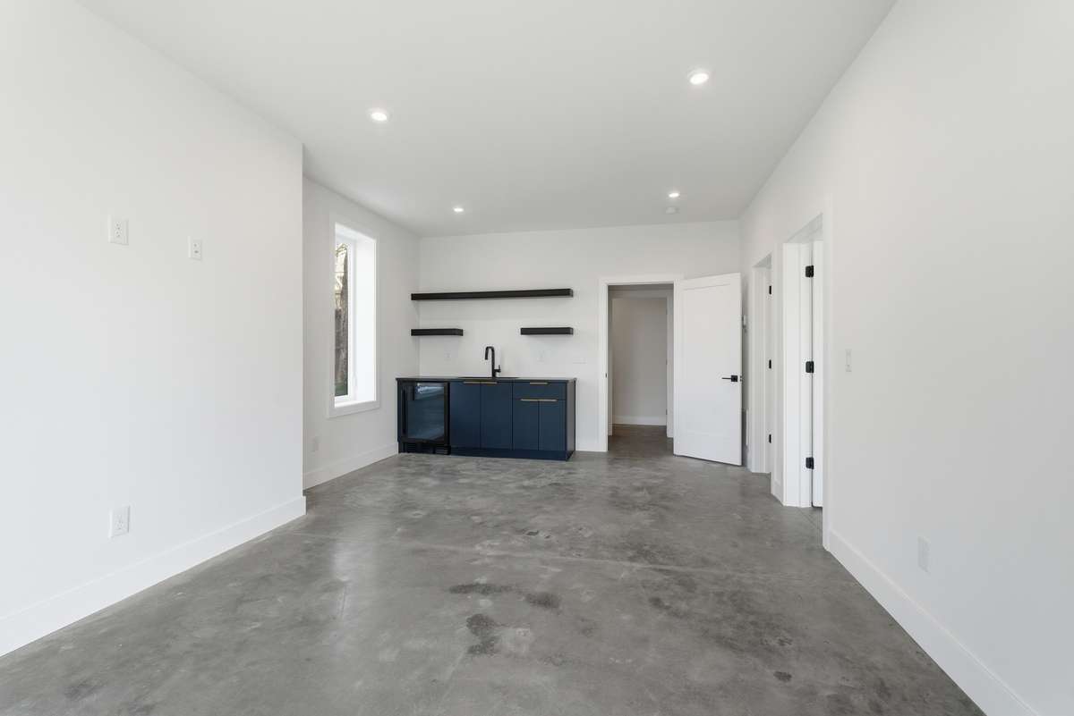 Lower Level: Attached Apartment / Flex space with a kitchenette and polished concrete floor.