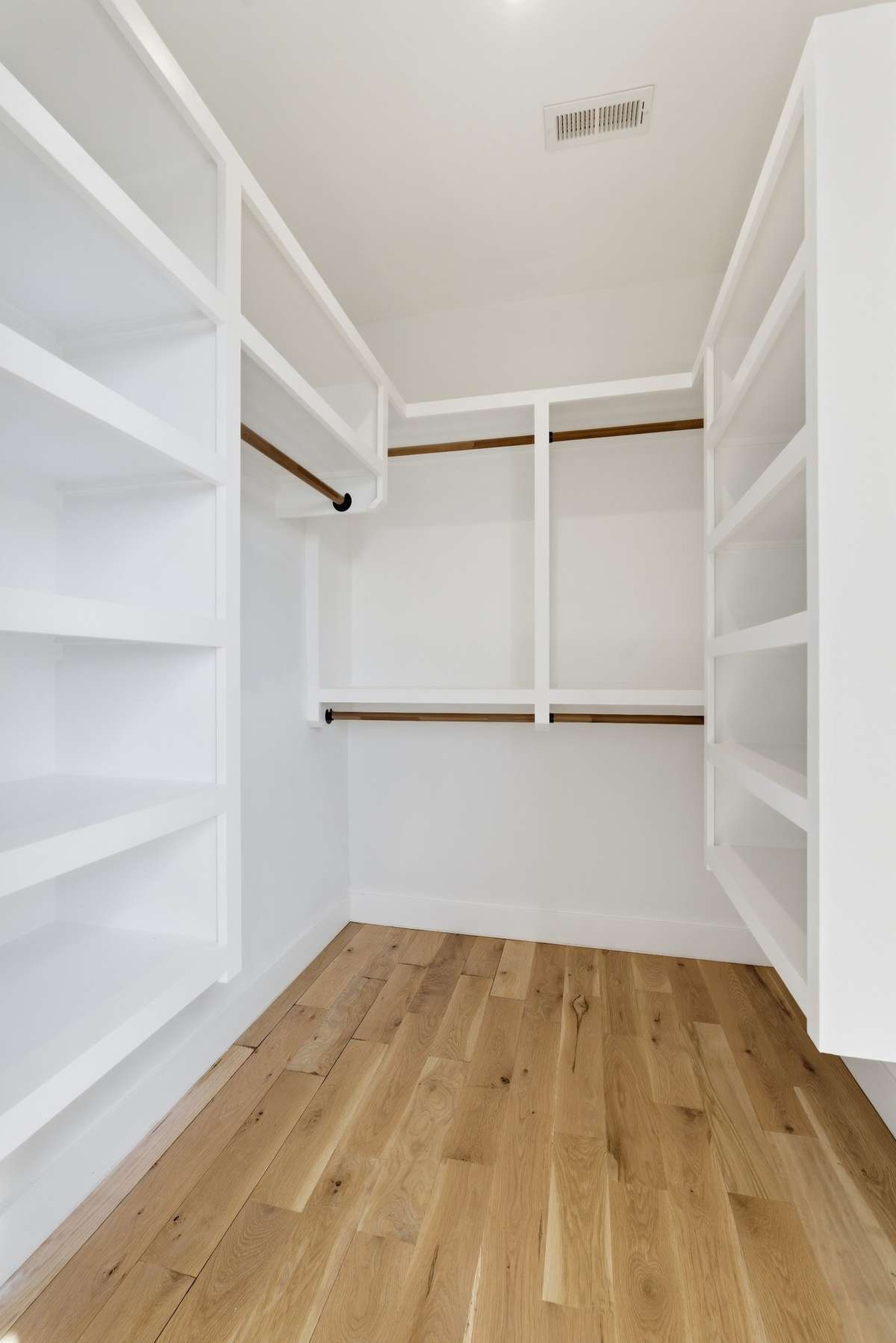 Bedroom 2 spacious walk-in closet with custom shelving and clean, modern lines, designed for effortless organization and everyday ease.