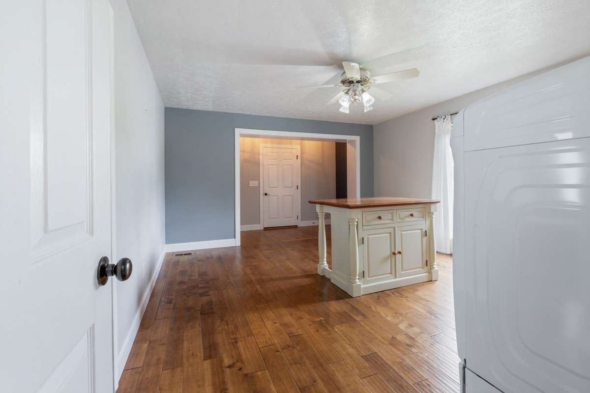 Flex room currently used as downstairs laundry. Could be dining room, office etc. Island is movable