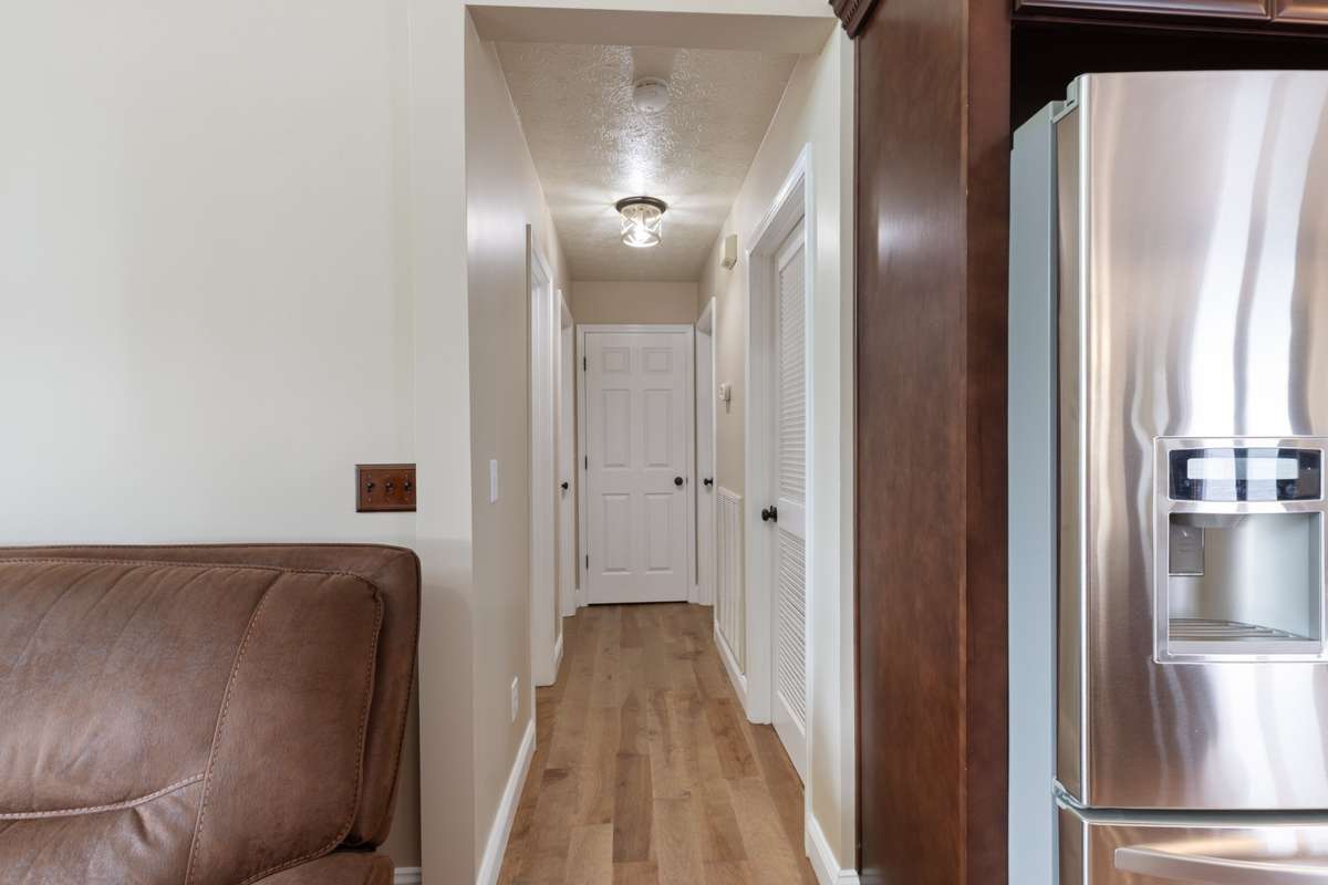 Hallway to 2 downstairs bedrooms, full bath and pantry.