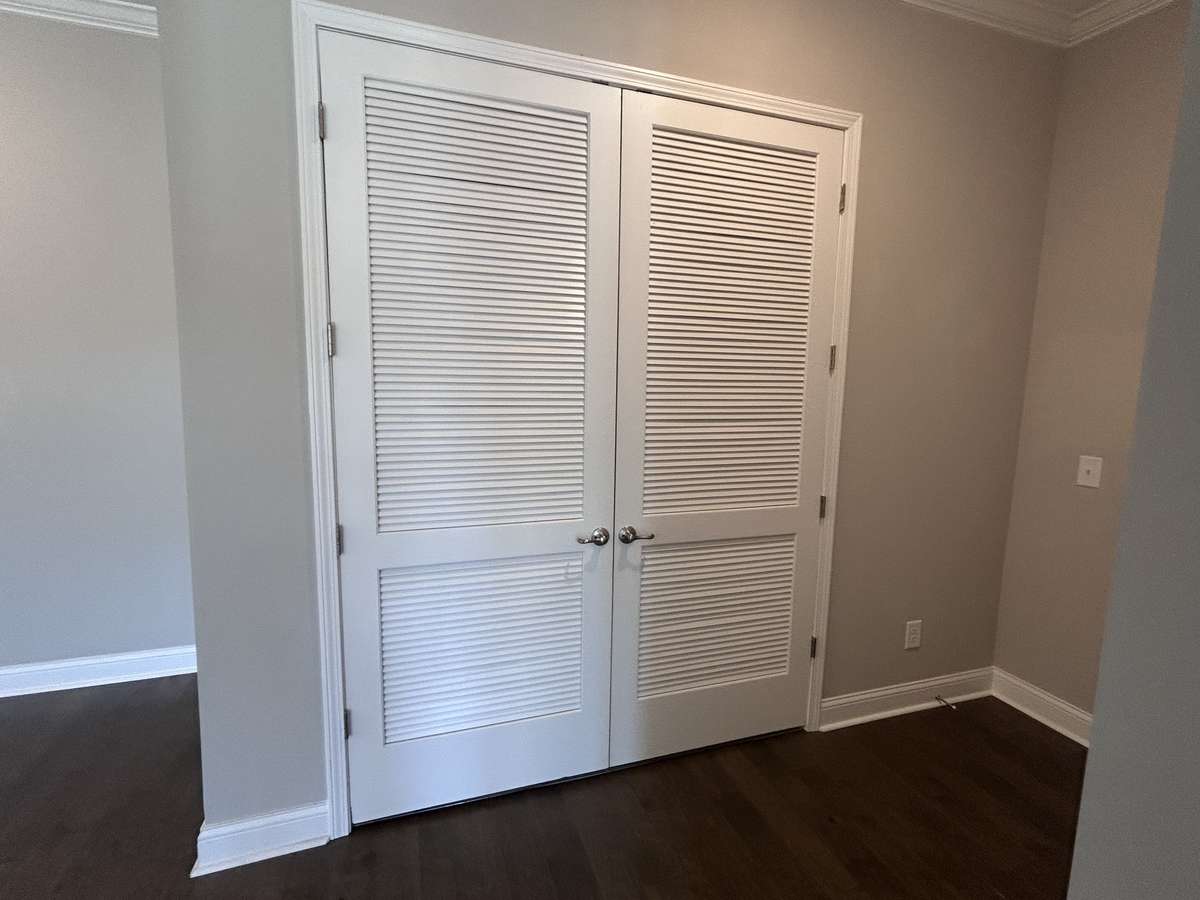 Laundry area accommodates full size washer dryer with beautiful 8 foot tall louvered doors