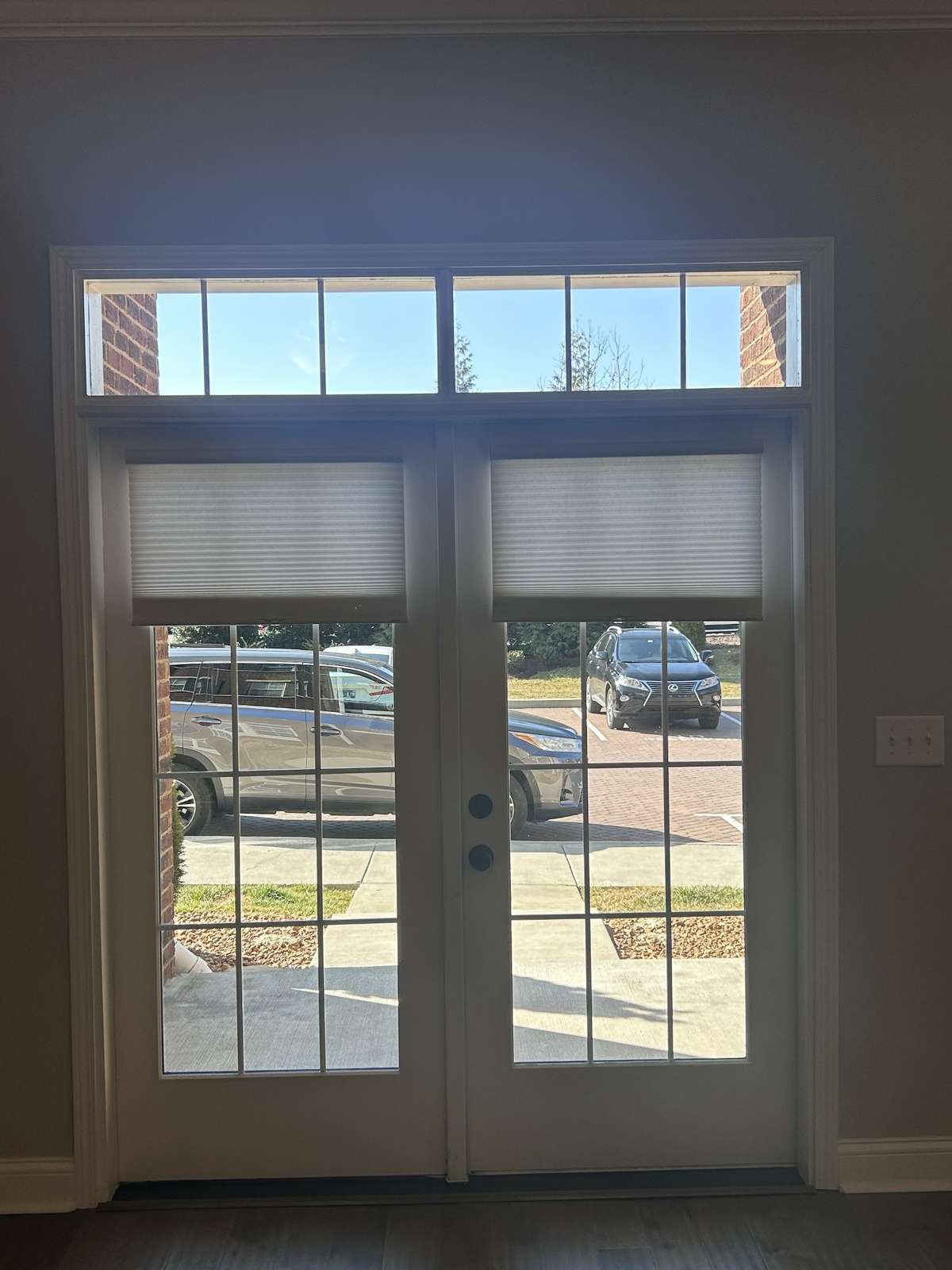 Gorgeous French doors leading out side. This is your private entrance and such a great option to be able to come and go without having to enter through the building. Window treatments stay.