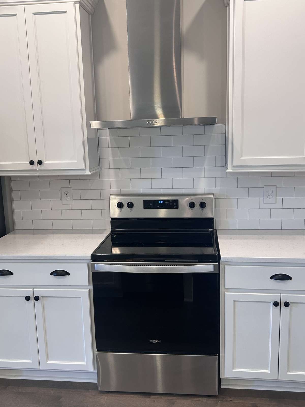 Beautiful white ceramic subway tile back splash, stainless steel range and hood. Quartz Counter Tops, 42"  upper cabinets