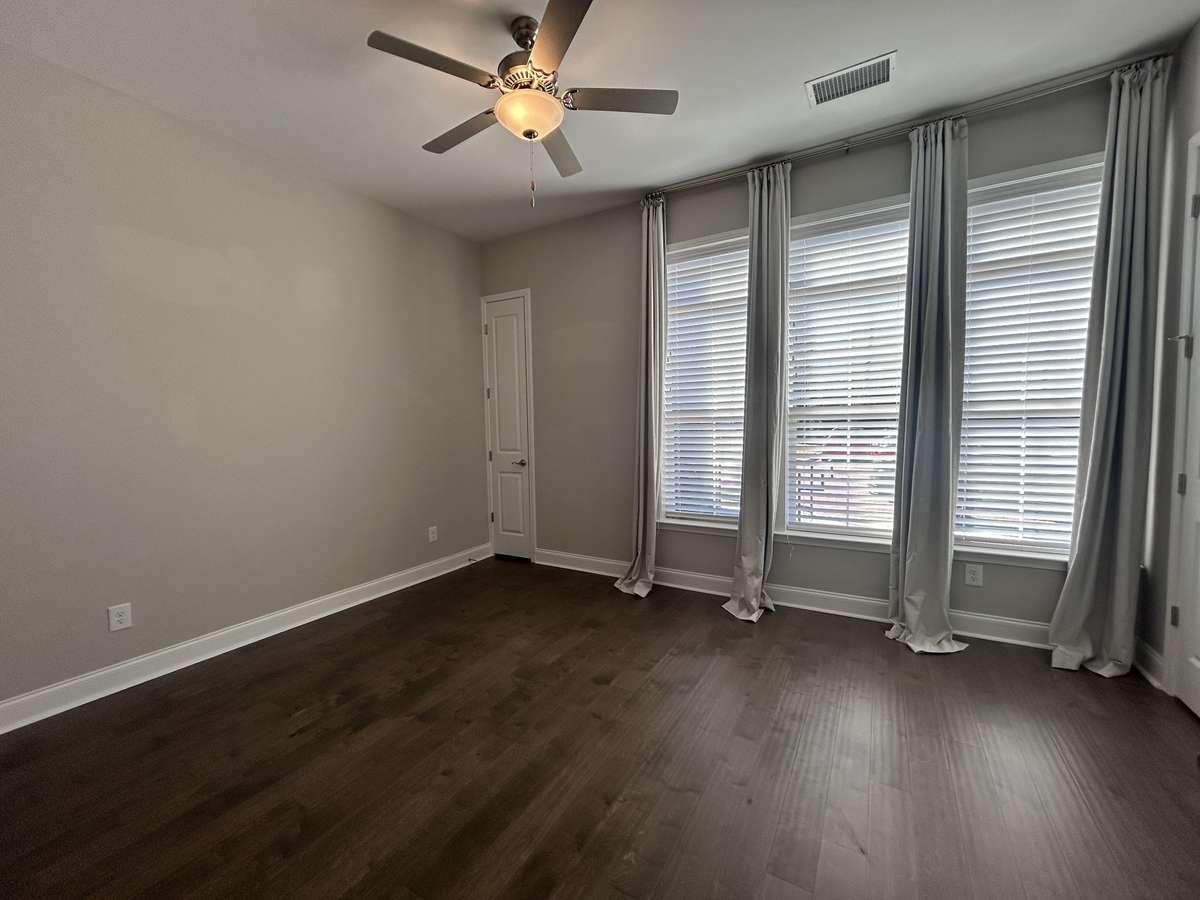 2nd Bedroom with Tall windows 2 closets and window treatments stay.