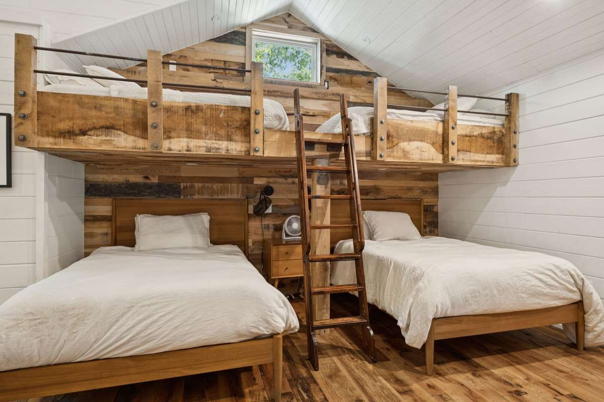 Large bedroom on the main level with building in bunkbeds.
