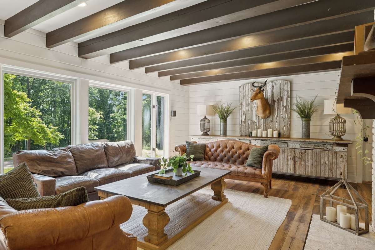 Incredible den with exposed beams and large rock fireplace.