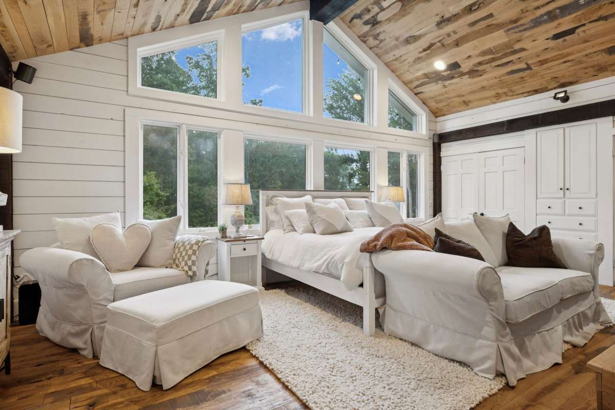 Upstairs Master Suite with exposed wood ceiling and natural light!