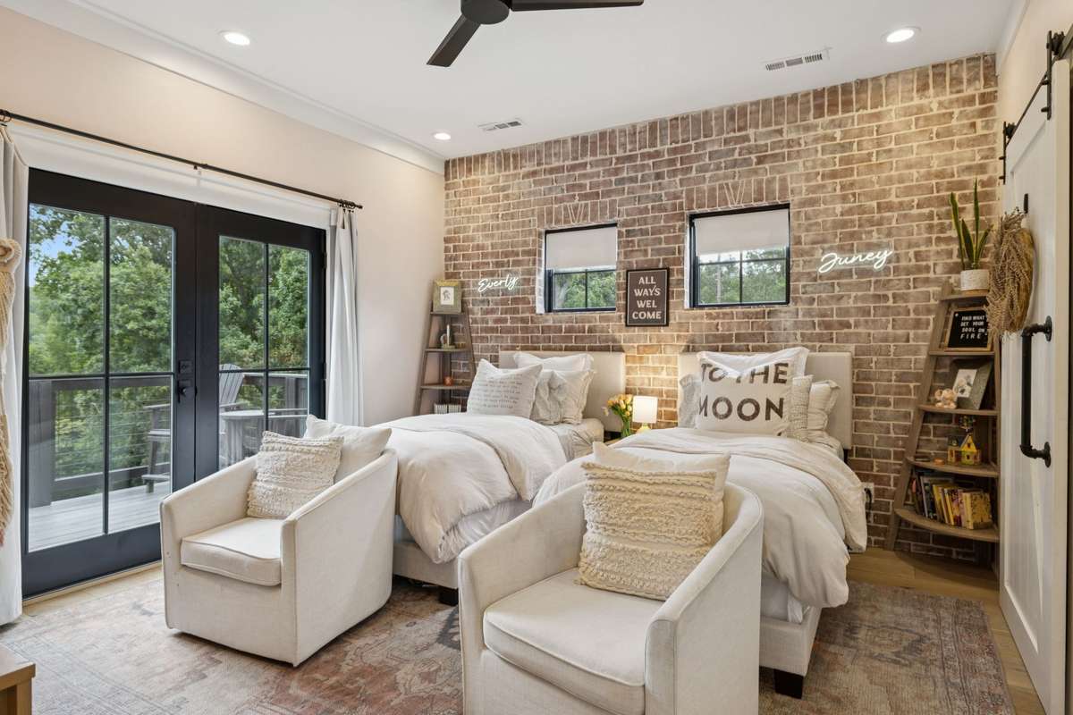 Upstairs Bedroom with brick accent wall.