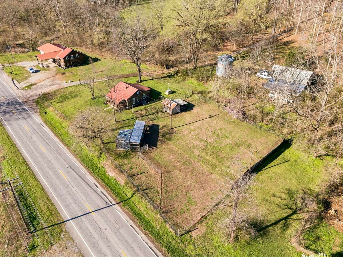 Better view of the home with fenced yard and additional paddocks / animal outbuildings.