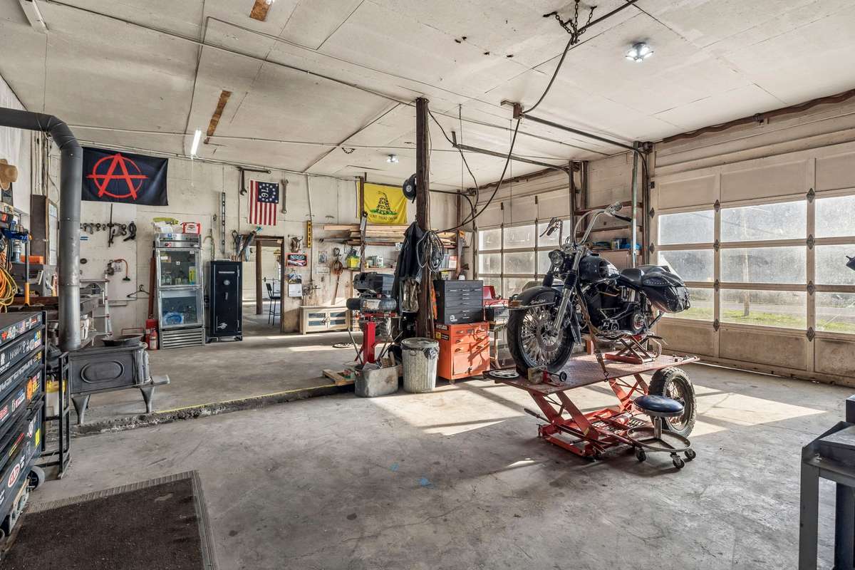 Workshop with 2 bays. 220v wiring with compressor wired in and plumbed throughout the shop. Also 220v welder hookups. Wood burning stove for winter time.