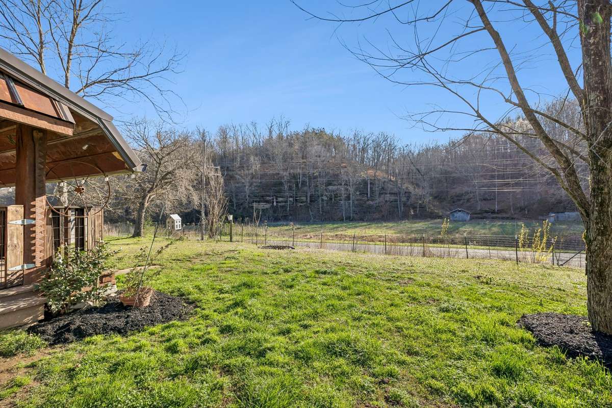 A sample of the view you'll get from the front porch. Notice the bluffs. There is also a small stream / creek that runs across the road.