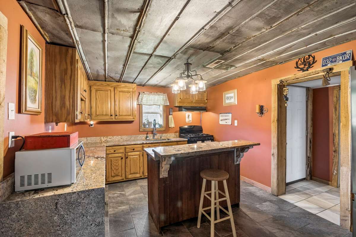 Large kitchen relative to the home. Ample counter space, granite countertops plus kitchen island.