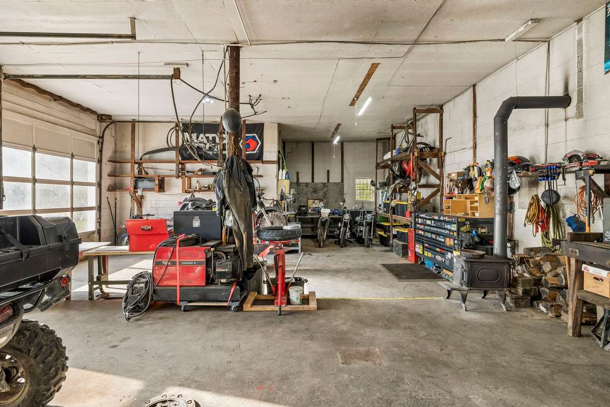 Workshop with 2 bays. 220v wiring with compressor wired in and plumbed throughout the shop. Also 220v welder hookups. Wood burning stove for winter time.