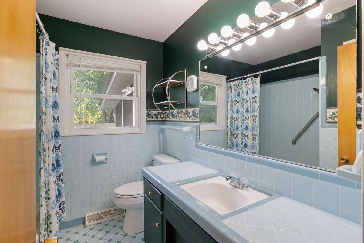 Halll Bath with tile floors and Shower/Tub Combination