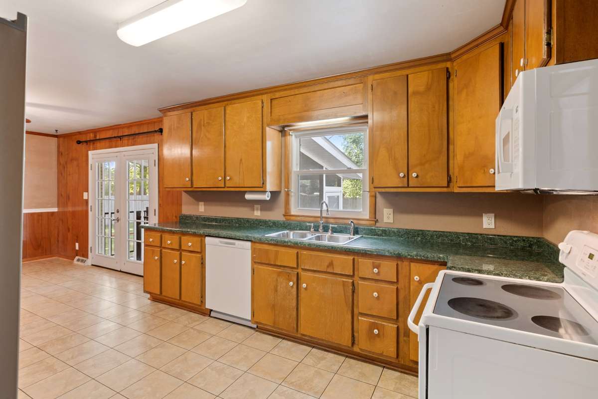 Larger View of Kitchen featuring all the cabinets and all the natural light coming in the windows