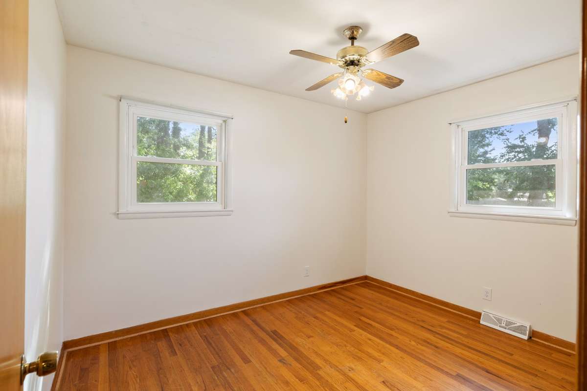 Bedroom #3  with Views from all the windows, ceiling fan, and real hardwood flooring