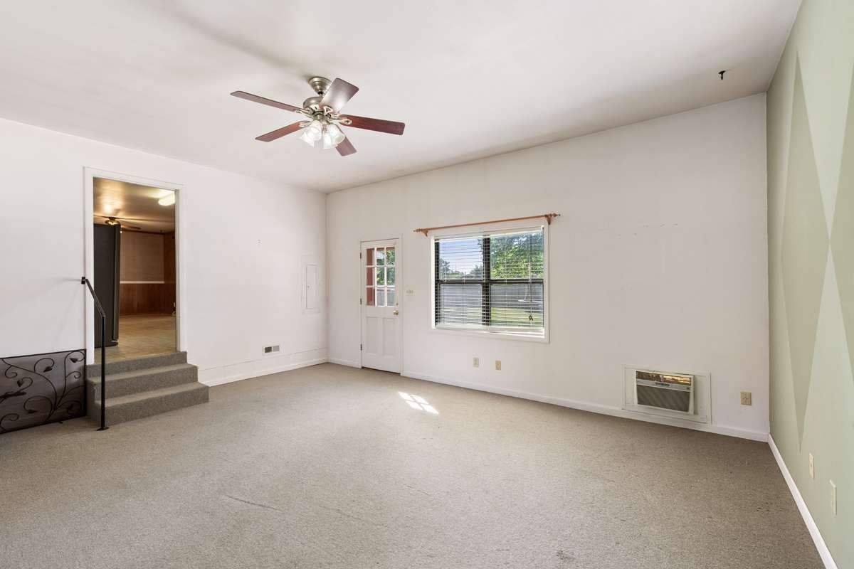 Another view of Den area with entry from outside .  It has a window air condition in the room for cooling.