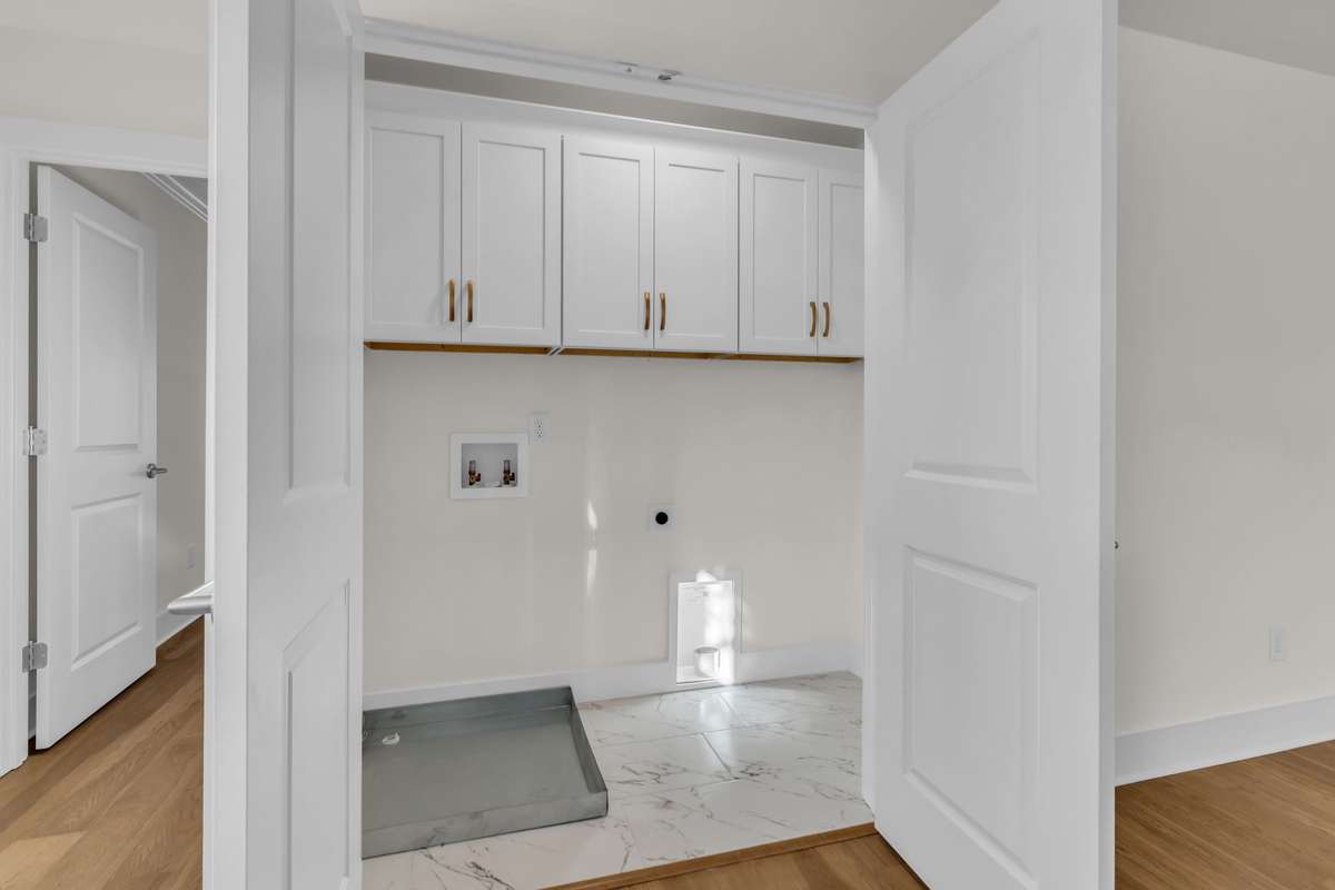 Laundry with built-in is upstairs close to all the bedrooms.