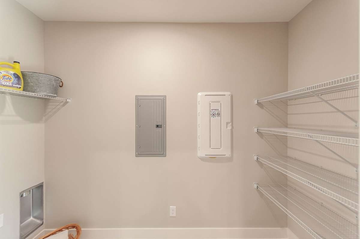 There is a large walk in laundry room with extra pantry storage as well.