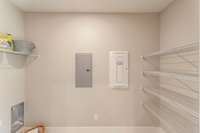 There is a large walk in laundry room with extra pantry storage as well.